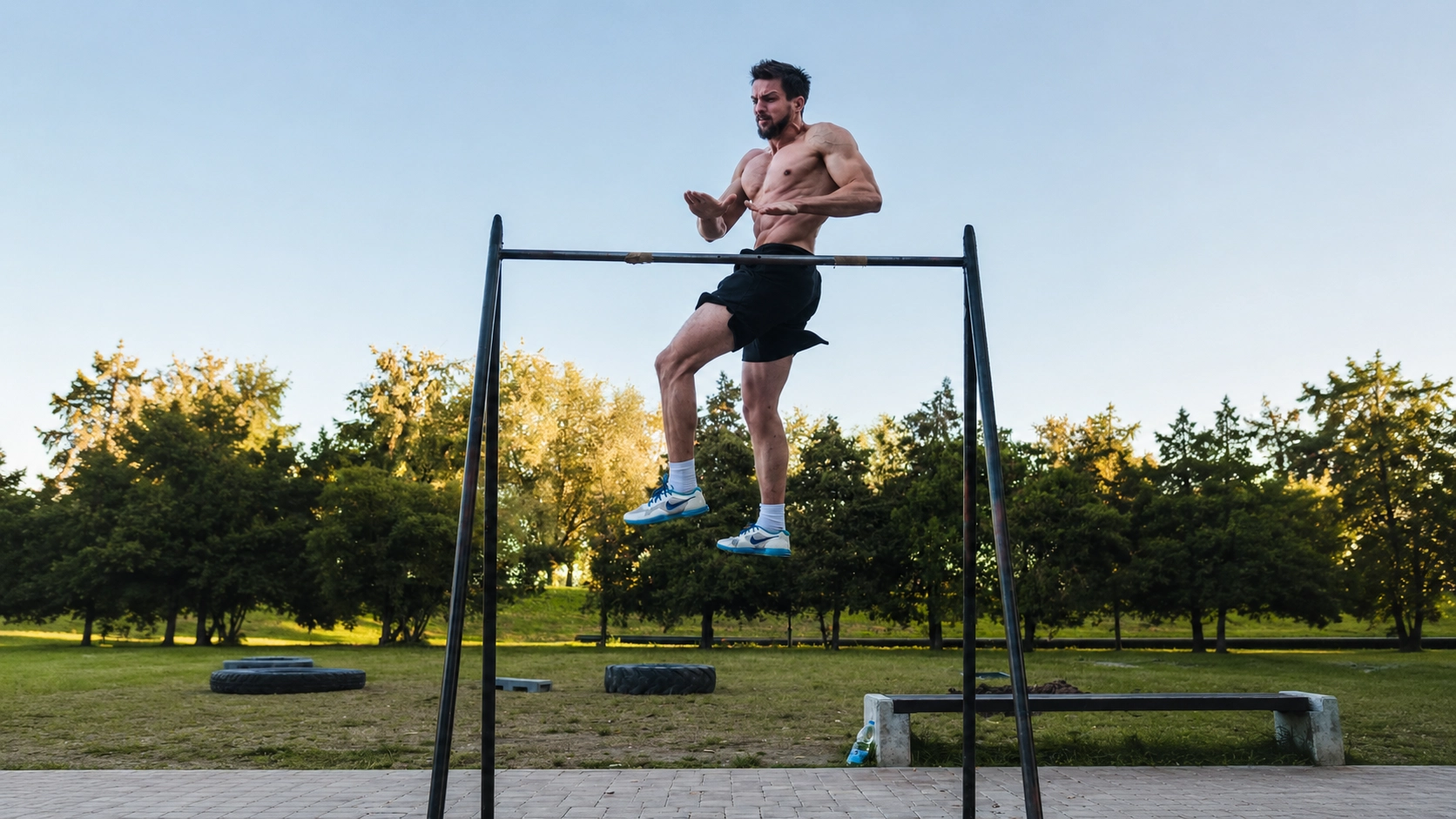 Man performing pull-ups on an outdoor bar demonstrating fitness and muscular definition for body fat assessment