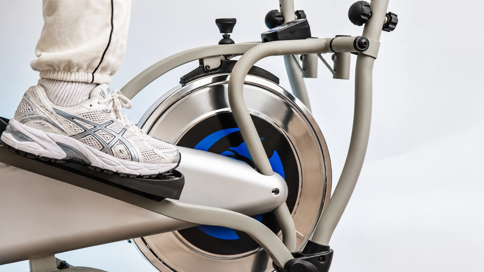 Person using a quiet elliptical machine with smooth pedal motion for low-impact cardio training