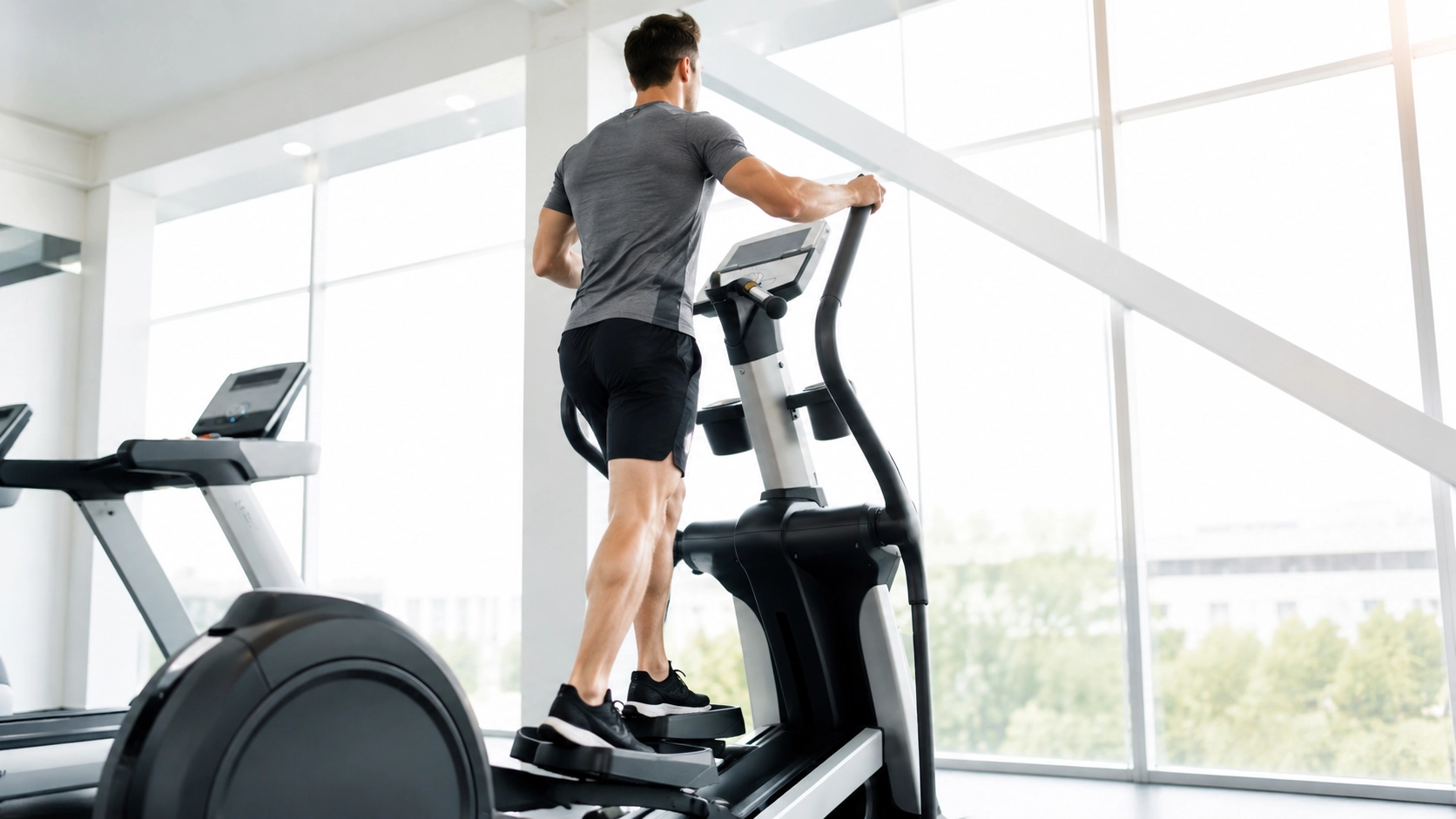 EM quite for for Apartments from 200 to 400 1 Man exercising on a quiet elliptical machine in a bright apartment setting with large windows
