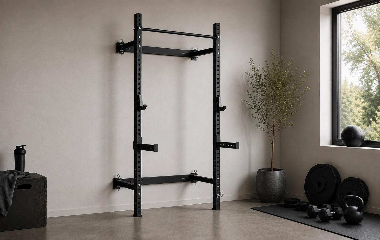 Wall-mounted power rack with adjustable safeties in a minimalist home gym with kettlebells and weight plates