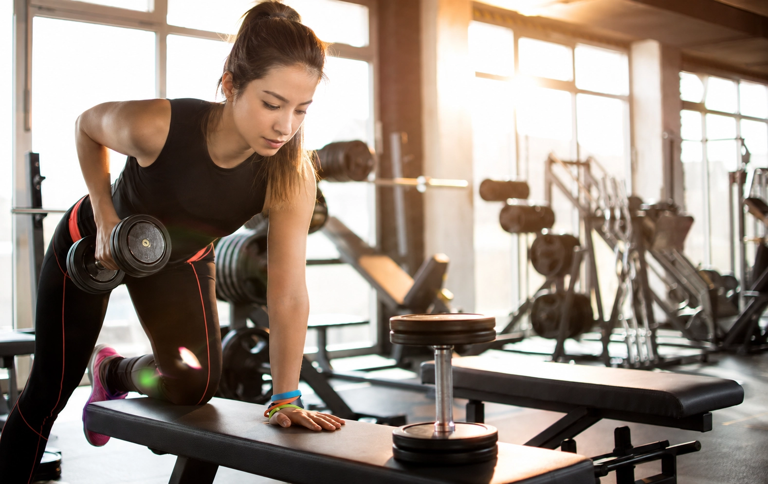 Woman performing a dumbbell exercise with proper grip and form demonstrating the importance of quality dumbbell selection