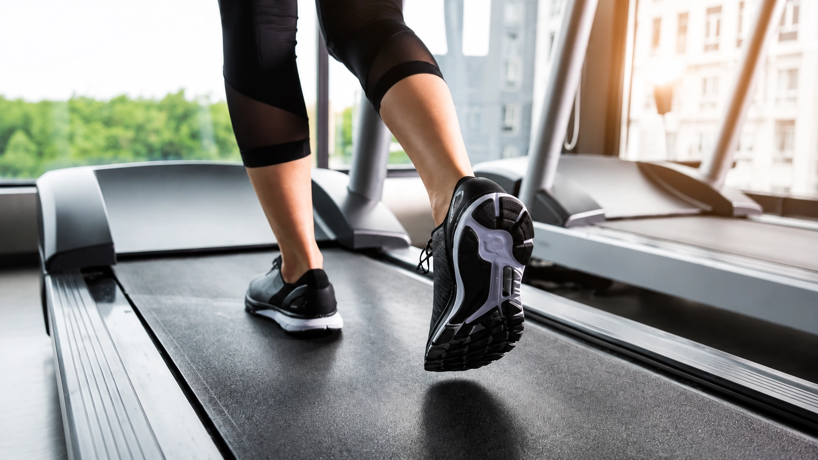 TM Commercial Grade for Home Use from 1000 to 1500 Woman running on a commercial-grade treadmill in a bright apartment with city skyline views