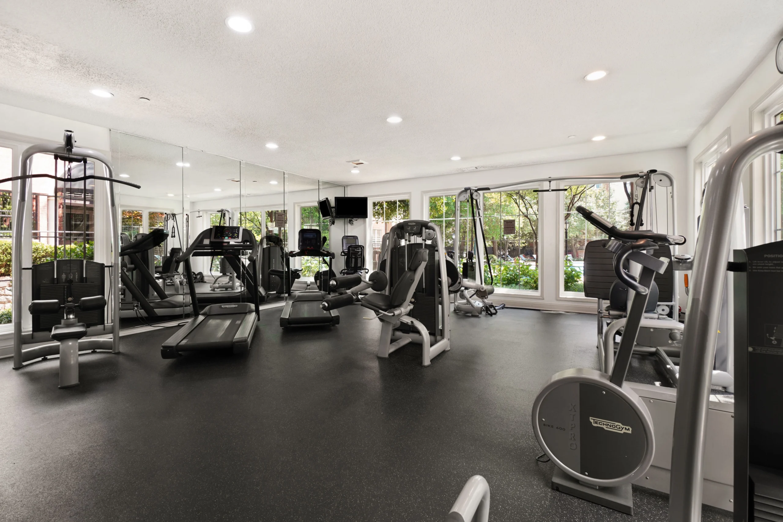 Treadmills for gym scaled Well-maintained home gym with clean treadmills and fitness equipment lined up