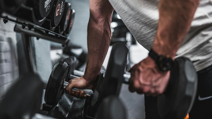 Close-up of hands gripping dumbbells during a lift, demonstrating proper handling technique