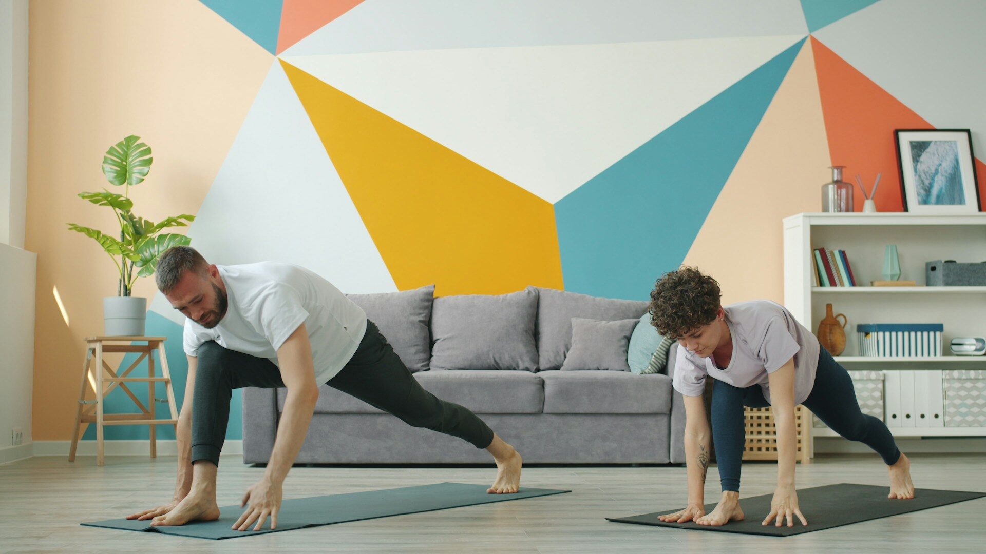 father and son doing a home workout on mats in the living ro Father and son doing a home workout on mats in the living room