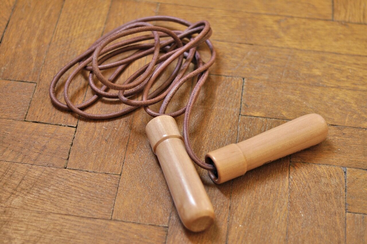 jump rope with wooden handles on a parquet floor Jump rope with wooden handles on a parquet floor