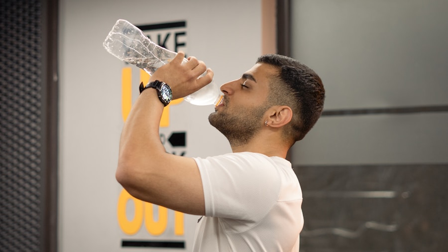Person drinking water after home strength training session with dumbbells