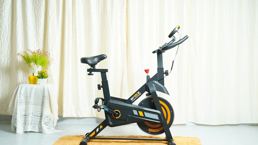 Person exercising on a compact, lightweight stationary bike in a home gym setting