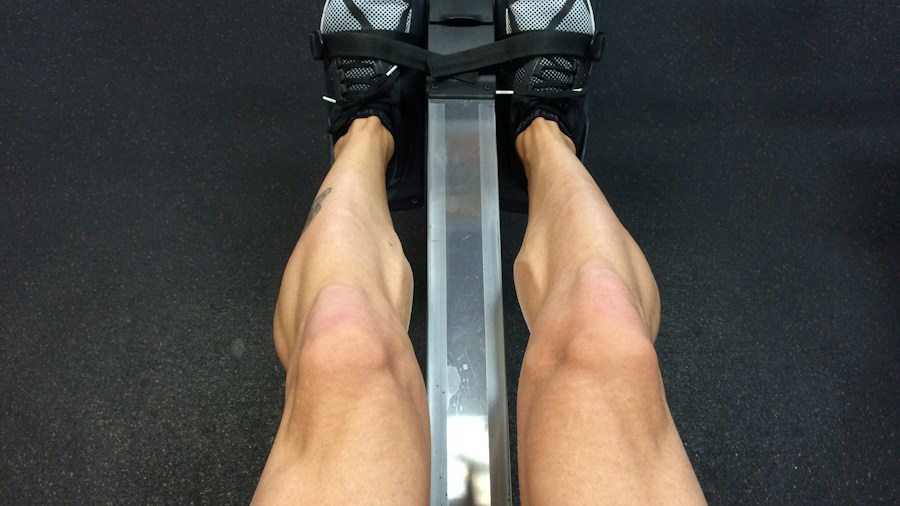 Person exercising on a quiet rowing machine in a home gym environment