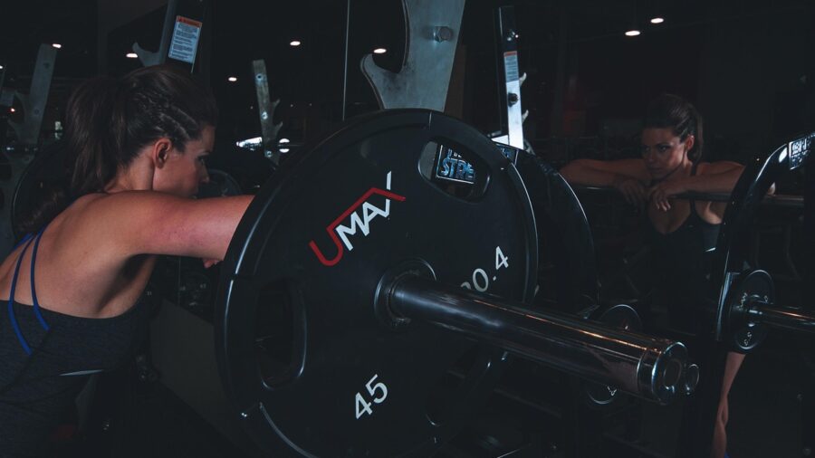 Person performing a barbell lift in a home gym during a quick 30-minute workout session
