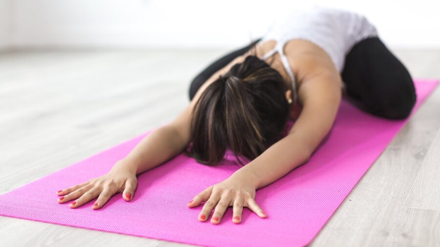 person performing a hamstring stretch to relieve post workou Person performing a hamstring stretch to relieve post-workout leg tightness