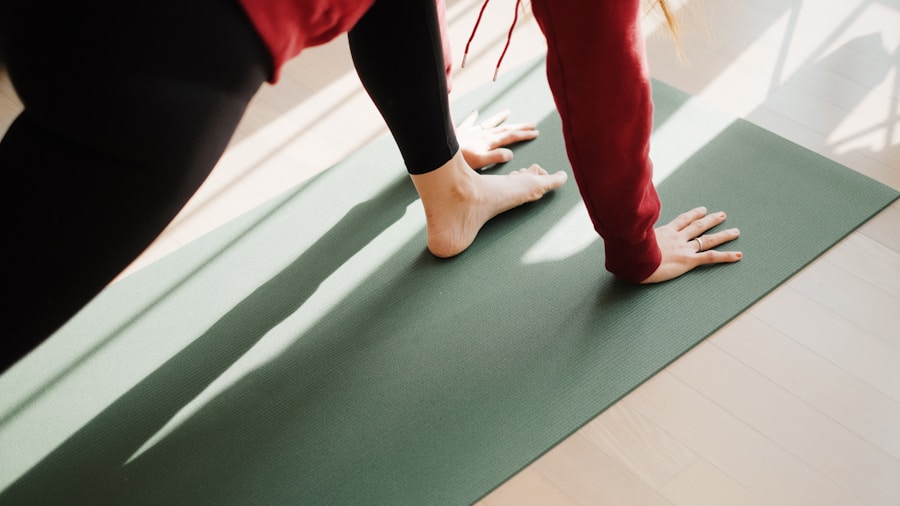 Person performing a hip stretch on a yoga mat at home for post-workout recovery