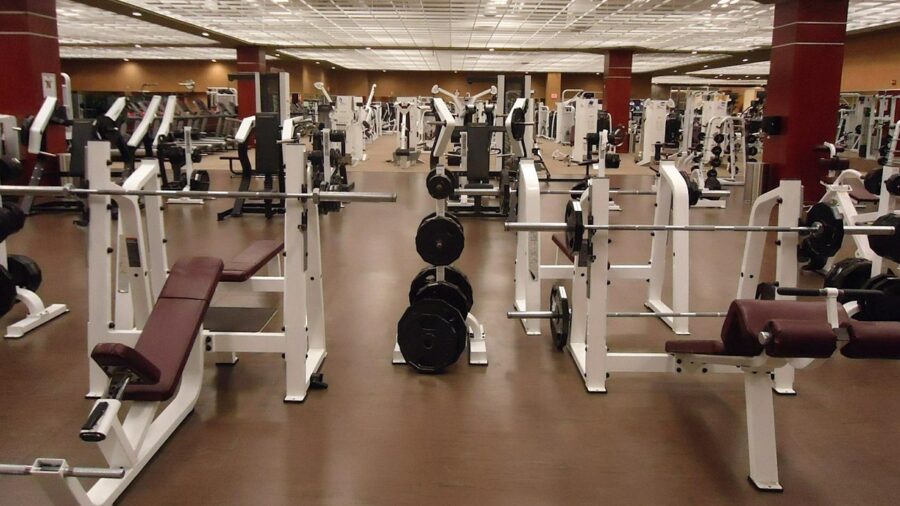 Person performing a squat exercise on a smith machine in a home gym setting