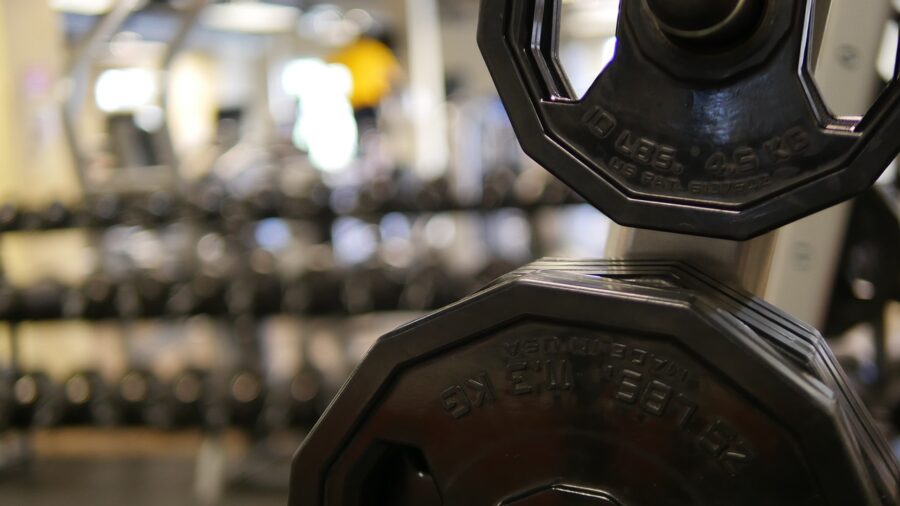 Person performing kettlebell exercise at home, showing practical kettlebell use and form