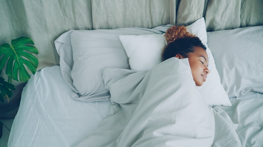 Person sleeping soundly in bed during daytime, demonstrating deep rest for exercise recovery