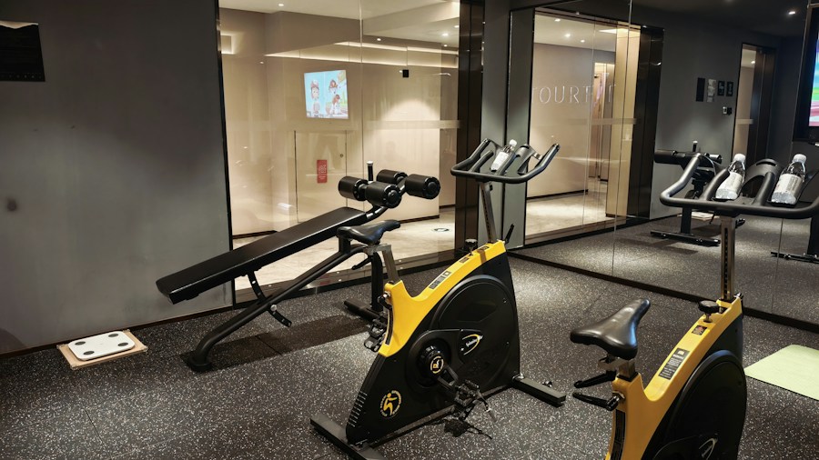 Person using a weight bench in a home gym setting with maintained upholstery