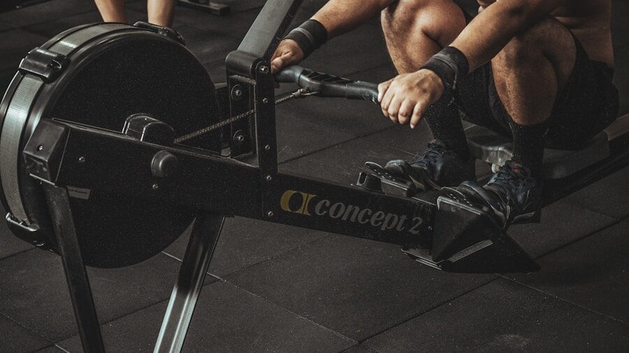 Person using an air rowing machine with proper form in a home gym