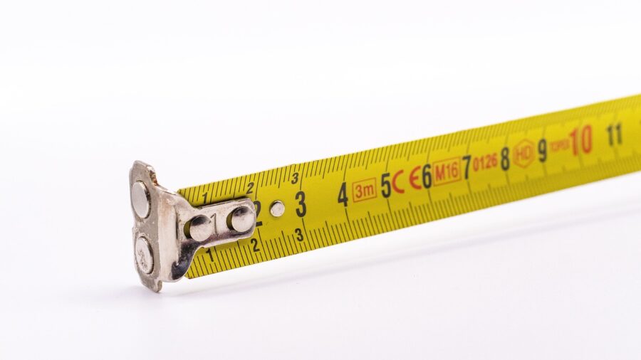 person using tape measure to check basement ceiling height f Person using tape measure to check basement ceiling height for Smith machine space planning