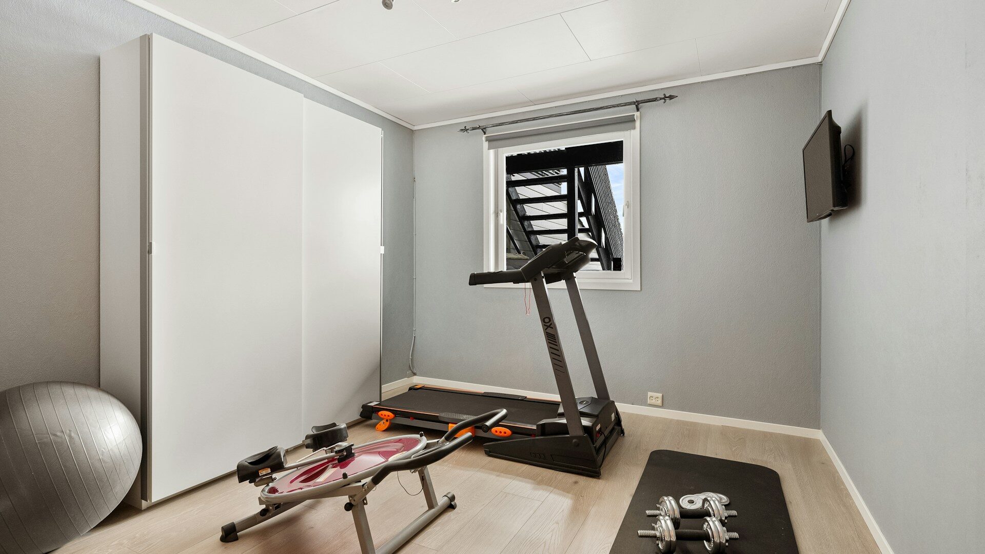 small home gym room with a treadmill weight bench and Small home gym room with a treadmill, weight bench and exercise ball