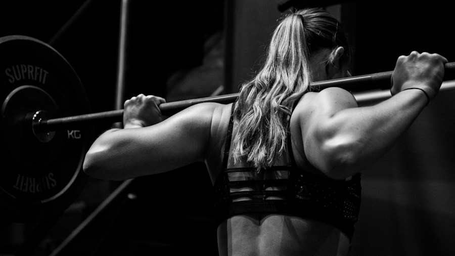 Strength athlete performing barbell exercise in power rack for structured workout routine