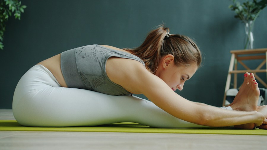 Woman performing stretches on yoga mat for post-kettlebell workout recovery
